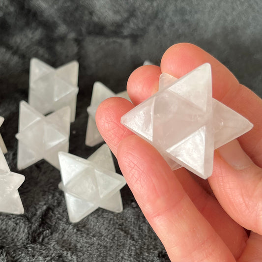 Large quartz merkaba stones, radiant with crystalline energy, ideal for meditation and spiritual practices.