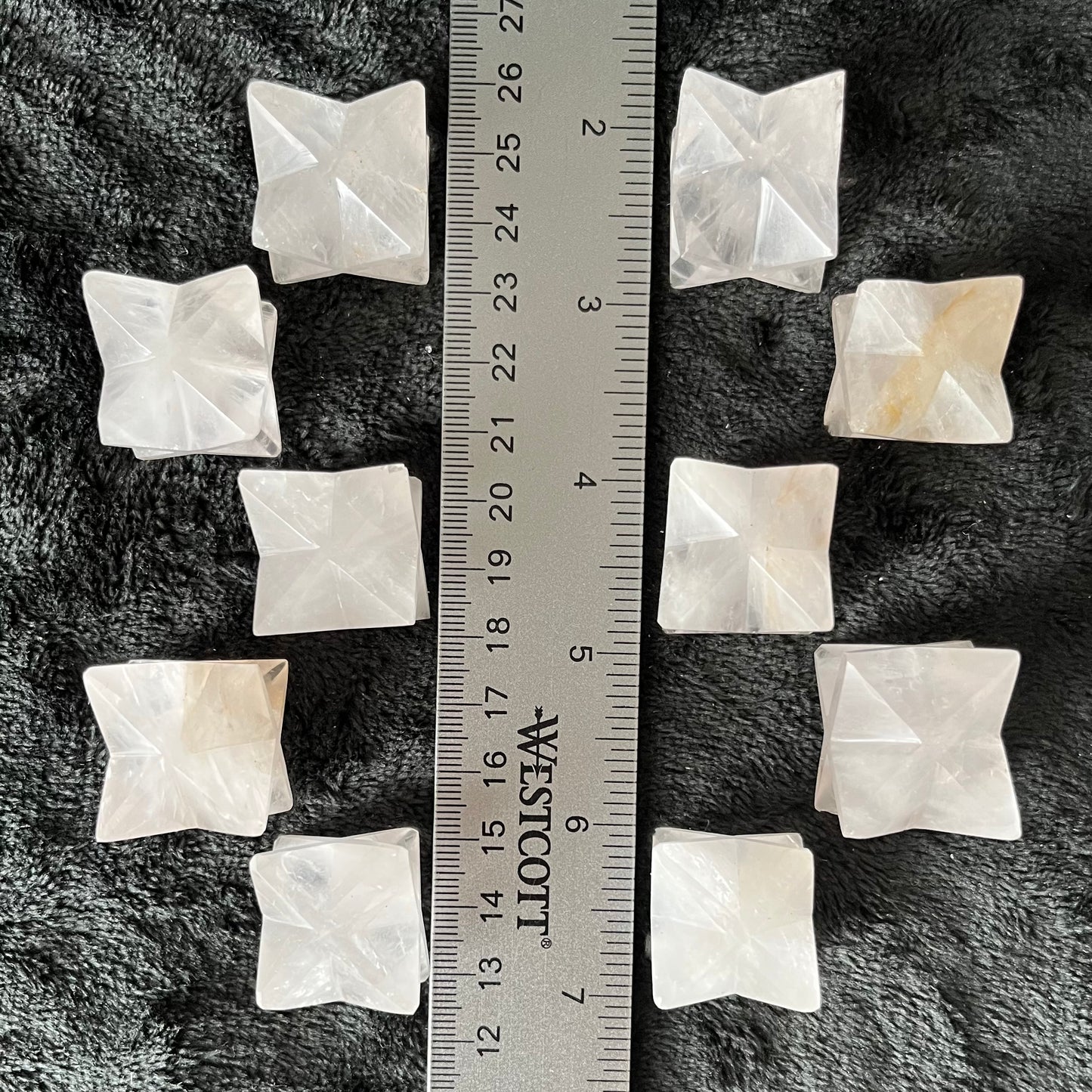 10 Large quartz merkaba stones, radiant with crystalline energy, ideal for meditation and spiritual practices, displayed next to a ruler. Quartz McCall the stones are approximately 1 inch in diameter.