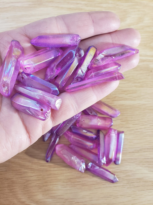“Sparkling pink aura quartz beads held in a xipped hand - radiating gentle elegance and positive energy