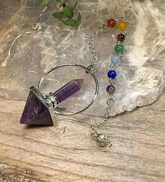 2 inch amethyst pendulum including an inverted amethyst pyramid attatched to an amethyst crystal in a silver ring, suspended from an 8 inch silver chain including chakra beads