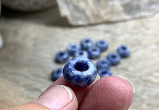"Close-up of vibrant 14mm Sodalite beads, showcasing their rich blue hues and natural patterns.