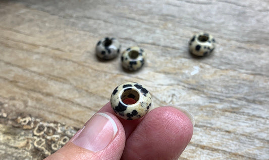 Dalmatian Jasper 14mm beads: Round beads with a 14mm diameter, featuring the distinctive Dalmatian Jasper pattern of creamy beige and black spots, resembling the coat of a Dalmatian dog.
