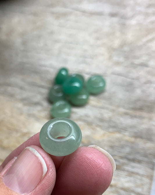 "Close-up of 14mm round green Aventurine beads, showing their smooth surface and rich color.