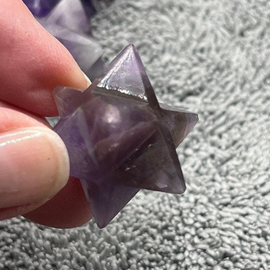 Amethyst Merkaba, a geometrically carved sacred shape in radiant purple, embodying spiritual transformation and higher consciousness.