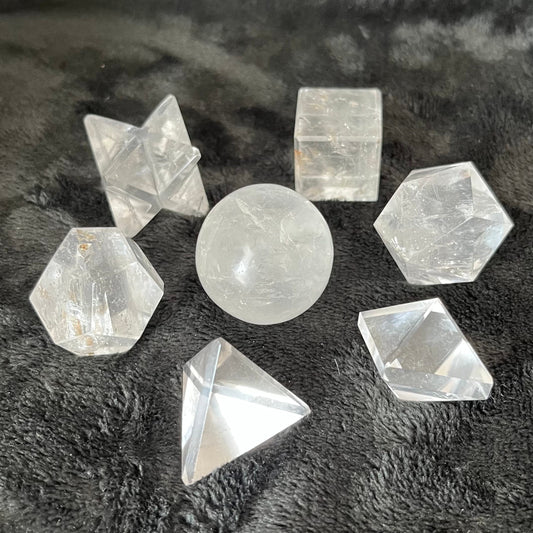 A stunning arrangement of seven quartz crystals, forming sacred geometric patterns with intricate symmetry, reflecting the beauty and harmony of sacred geometry in natural quartz formations."