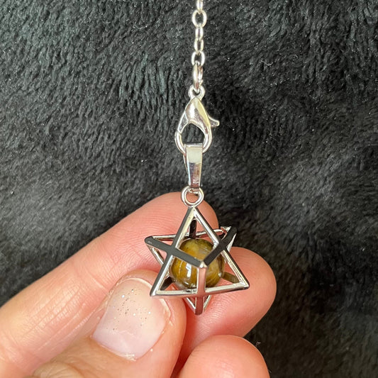 close up of a 1 cm shiny bronze and brown tigere eye sphere in a 1/2 inch sliver merkaba attatched to a 9 inch silver chain