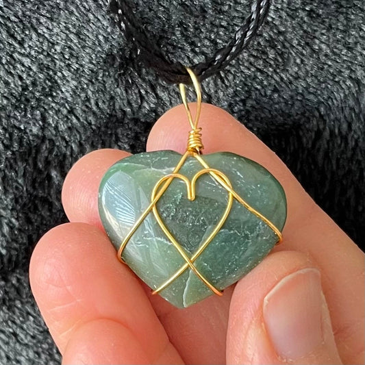 Gold wire wrapped, green jade heart pendant, approximately 3/4" X 1", attarched to an adjustable black cord.