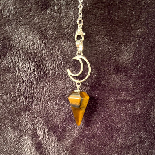 close up of a 1 inch bronze and brown marbled tiger eye  pendulum suspended from a silver creacent moon charm attatched to a silver 8 inch chain