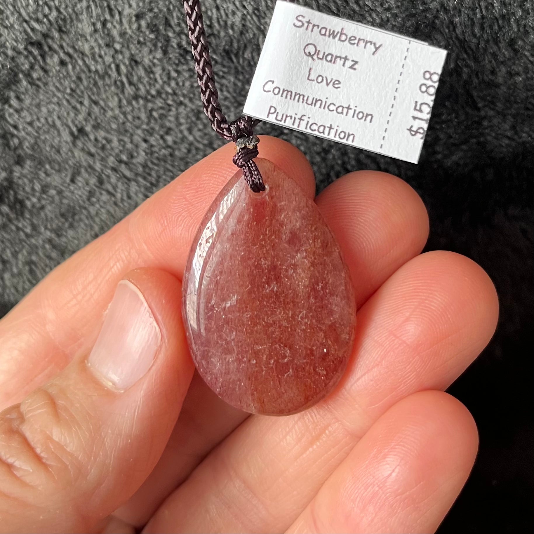 Radiant strawberry quartz teardrop pendant necklace, showcasing a sweet blend of pink hues in a captivating gemstone, elegantly suspended from an adjustable cord.