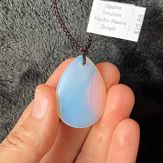 Iridescent opalite teardrop pendant necklace, embodying a mesmerizing play of pastel colors within the stone, gracefully hung from a delicate adjustable brown cord.