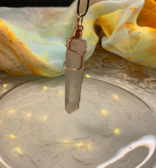 Beautiful, handmade copper wire, wrapped quartz point pendant attached to an adjustable black cord.  Quartz stone is approximately 1 3/4” in length.