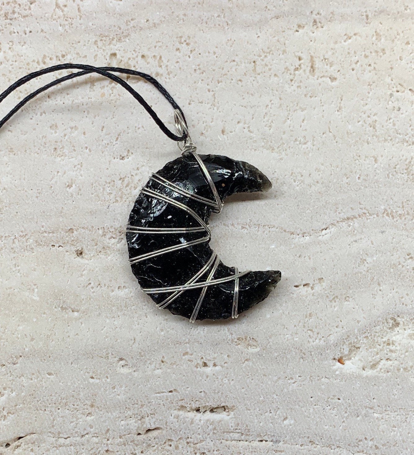 Silver wire wrapped obsidian crescent moon pendant with adjustable balck cord.