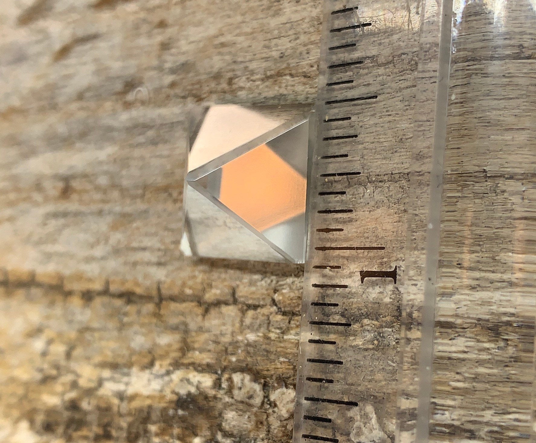 Small quartz pyramid display next to a ruler.  The base is approximately 1/2 inch in diameter.