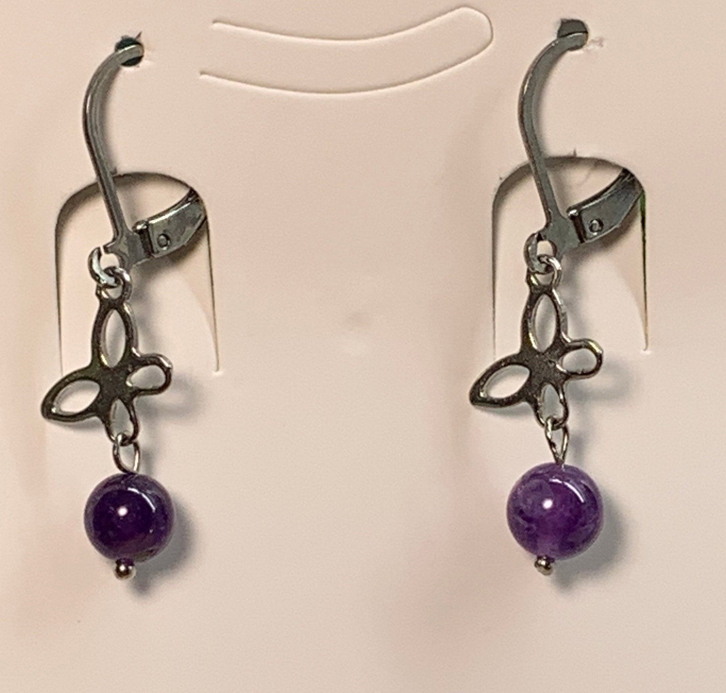 8mm purple amethyst beads suspended from a silver butterfly.  earrings are appoximately 1" long.  