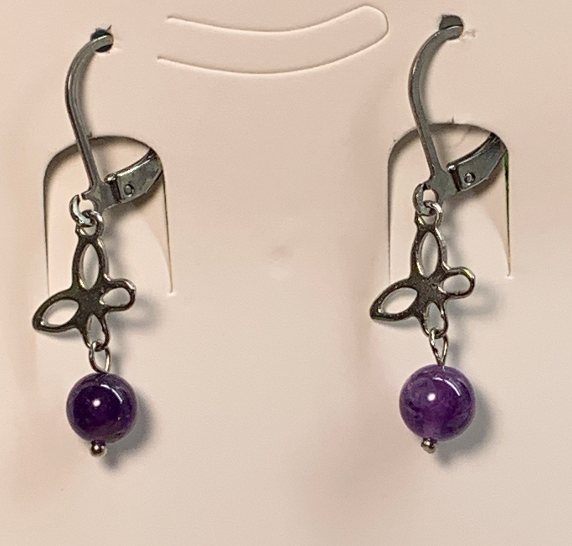 8mm purple amethyst beads suspended from a silver butterfly.  earrings are appoximately 1" long.  