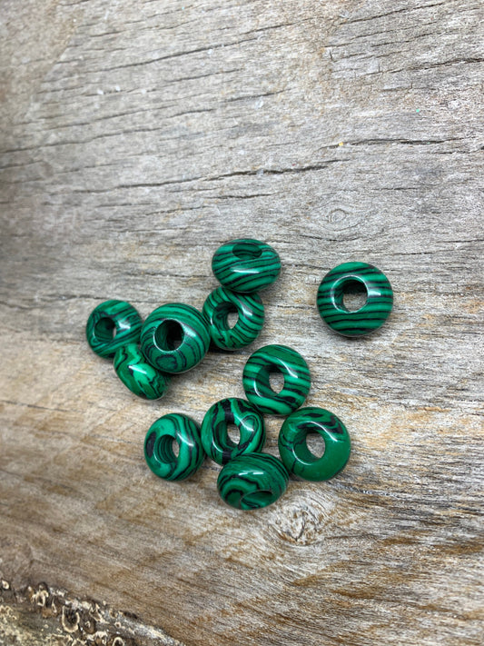 "Close-up of vibrant green malachite beads with unique striated patterns, creating an eye-catching accessory.