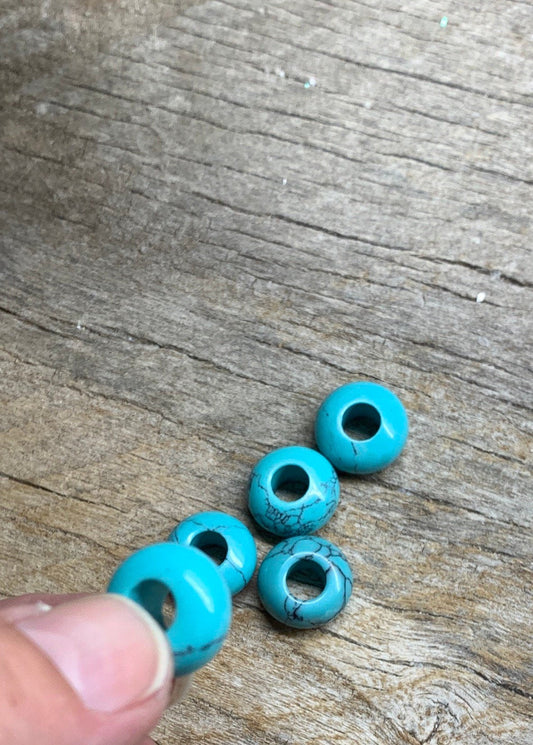 "Close-up of 14mm blue howlite crystal beads, showcasing their vibrant blue color and unique marbled patterns.