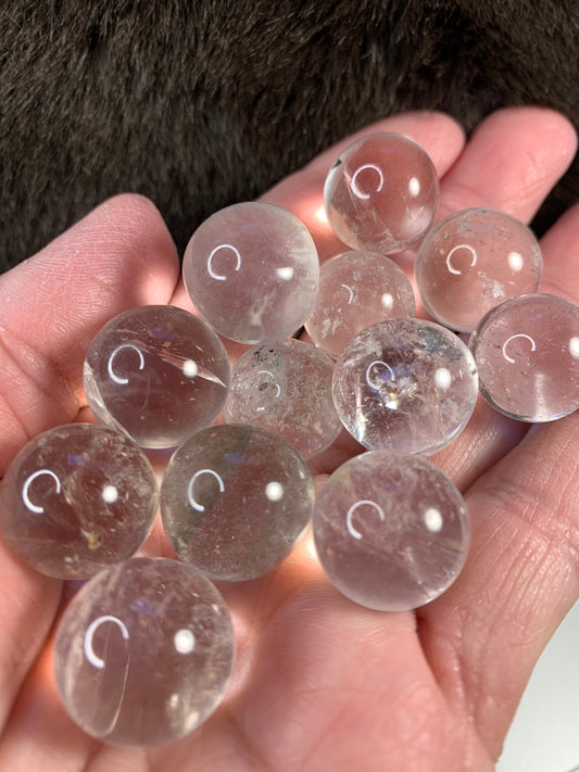 a handful of polished shiny clear quartz spheres 1/2" to 5/8" in diameter