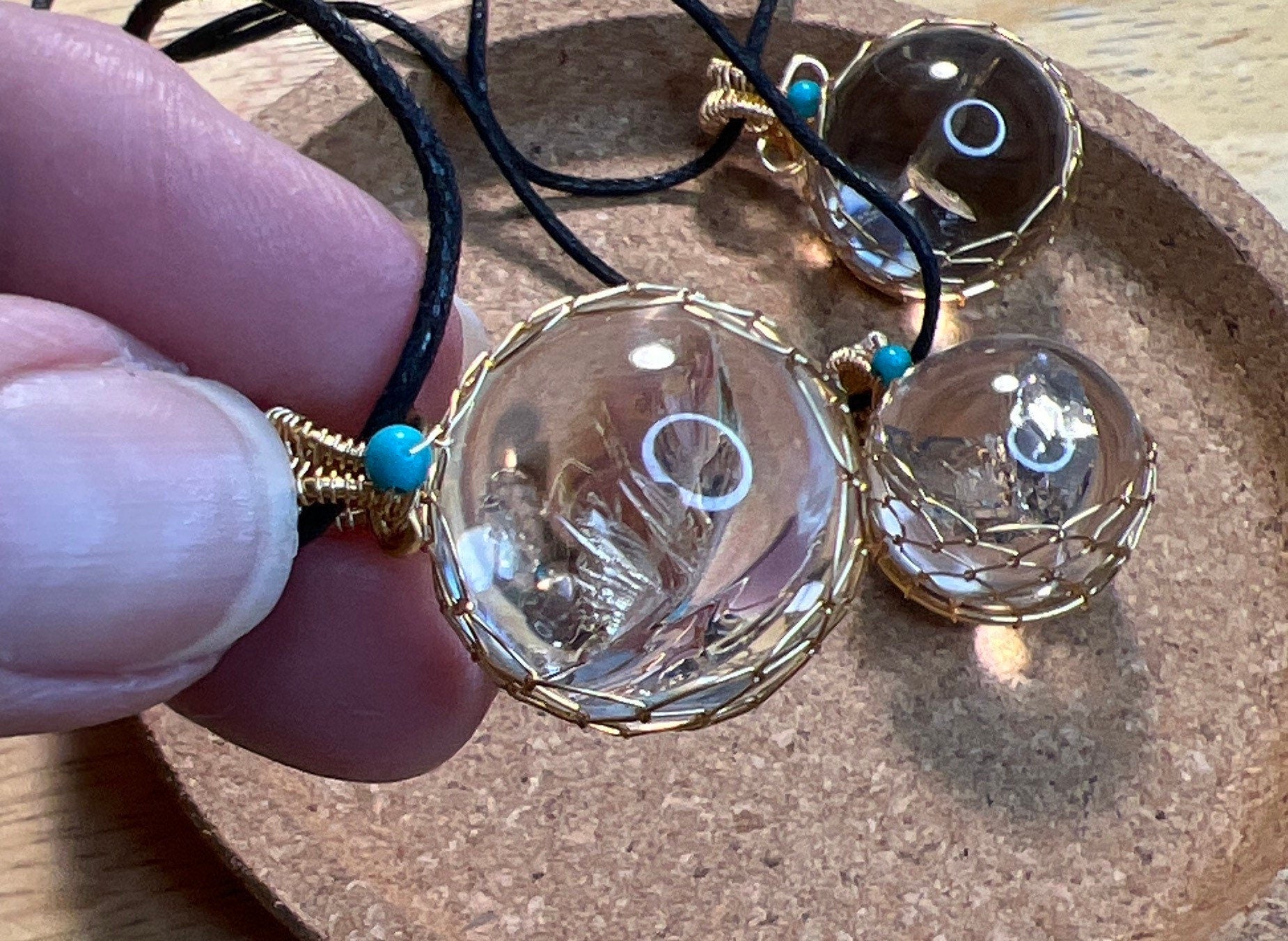 Handcrafted golden wire-wrapped necklace featuring a mesmerizing quartz sphere centerpiece approximately 1/2” in diameter