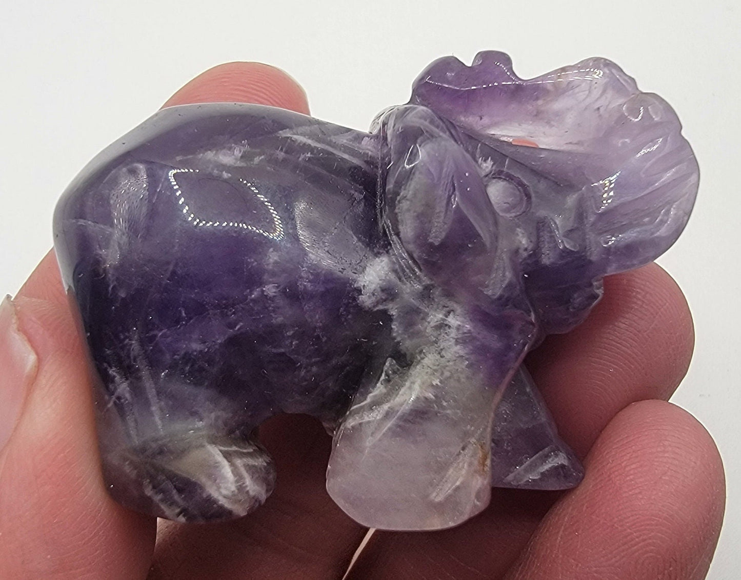 Amethyst elephant carving, showcasing intricately detailed craftsmanship and rich purple tones, symbolizing strength and spirituality.