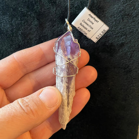 dragon tooth amethyst crystal silver wire wrapped pendant, approximately 2 inches long, attarched to an adjustable black cord.  