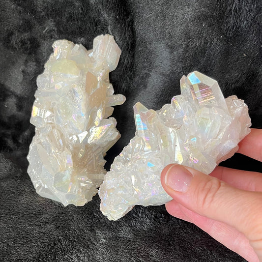 "Angel aura quartz cluster with iridescent rainbow colors, reflecting light and promoting a sense of peace and serenity.