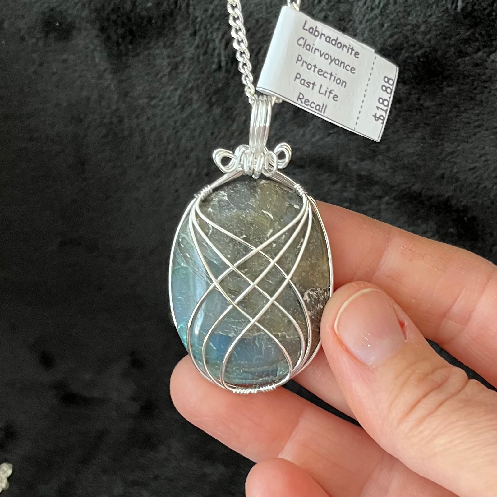 Fancy silver wire wrapped Labradorite Oval cabochon pendant, approximately 1 3/4" long, attatched to a silver chain