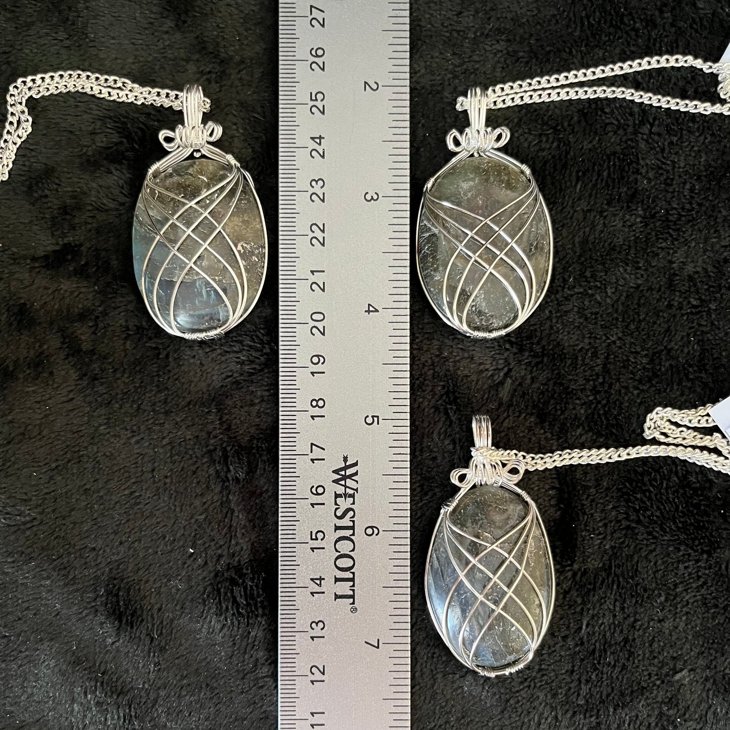3 Fancy silver wire wrapped Labradorite Oval cabochon pendants, approximately 1 3/4" long, attatched to silver chains, displayed next to a ruler