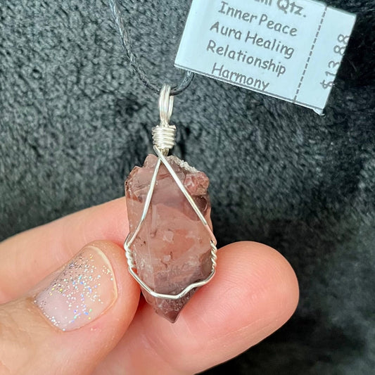 silver wire wrapped lithium quartz point pendant, with an adjustable black cord.  quartz crystal is apprximately 1" long.