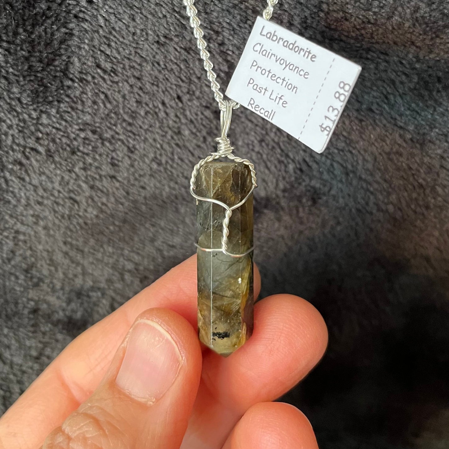 Silver Wire Wrapped Labradorite Point Pendant attatched to a silver chain.  stone is approximately 1 1/4" long