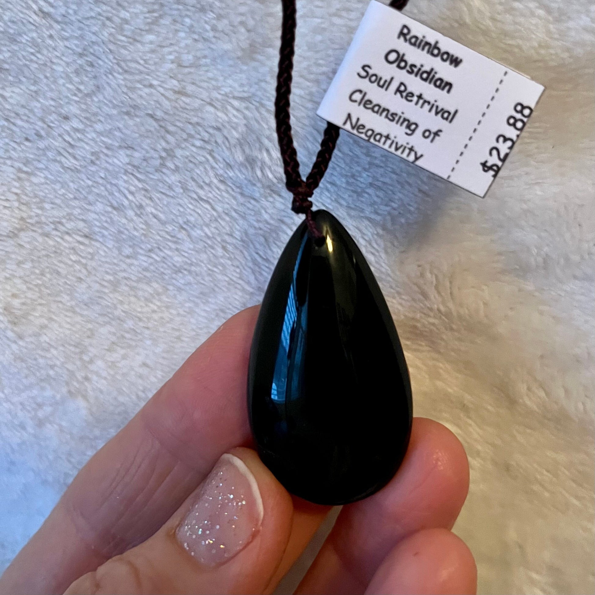 Iridescent rainbow obsidian tear drop pendant necklace, showcasing a spectrum of captivating hues, gracefully hung from a dainty chain for a touch of mystical beauty."
