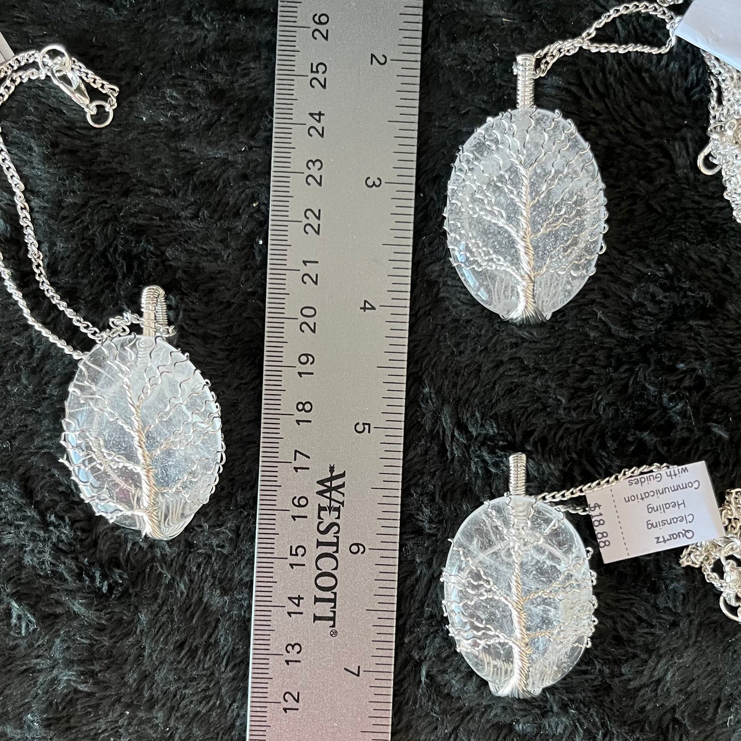  Fancy wrap, tree of life wire wrapped dazzling clear wuartz oval pendant attatched to a silver chain, displayed next to a ruler.  pendant is approximately 2 inches long