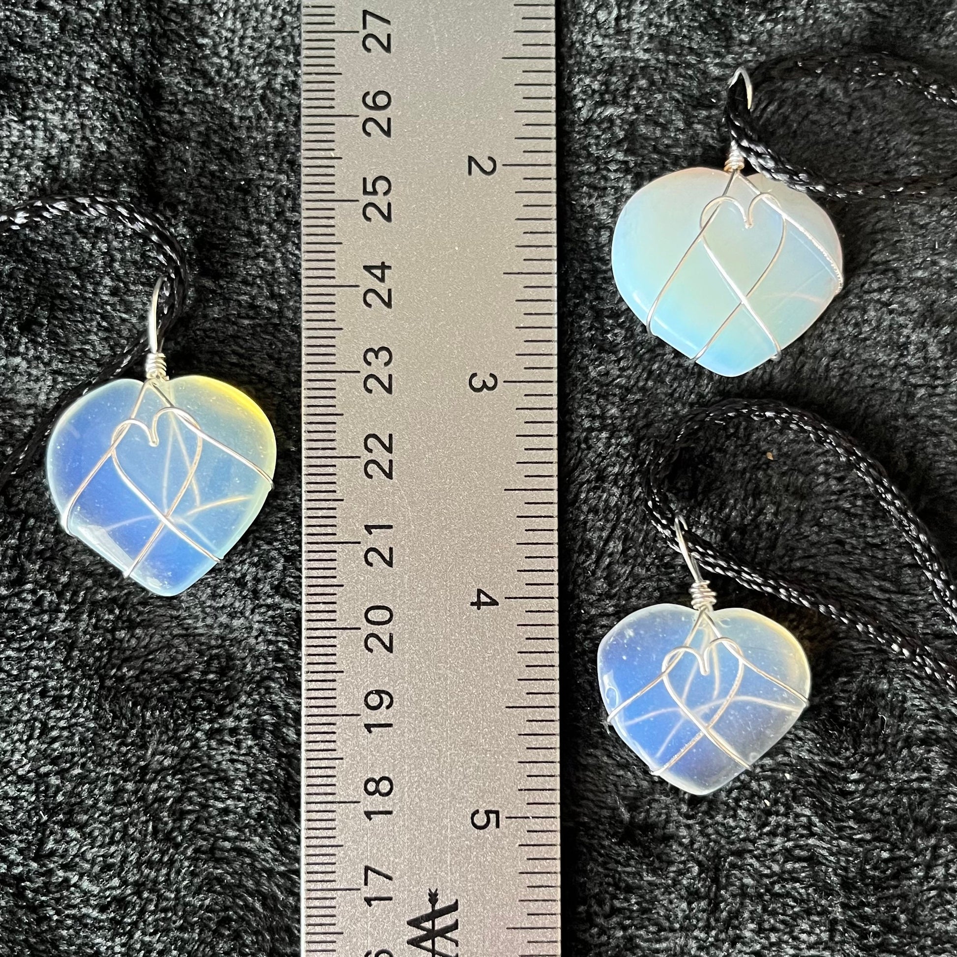 3 silver wire wrapped transluscent white opalite heart pendants, approximately 1" long, attatched to black cords