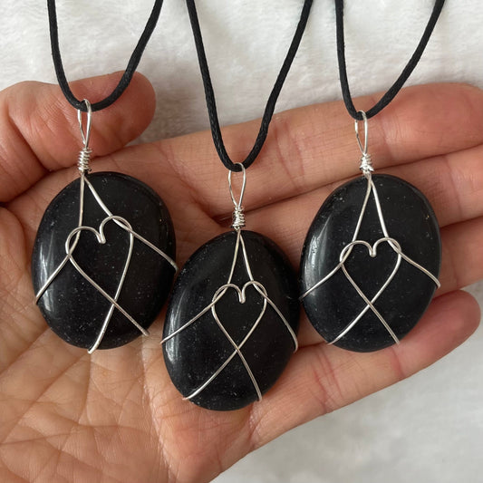 Silver wire wrapped obsidian worry stone pendants, with adjustable black cords.  obsidian crystal are approximately 1 1/2" long.  wire males a heart shape in the middle of the stones.